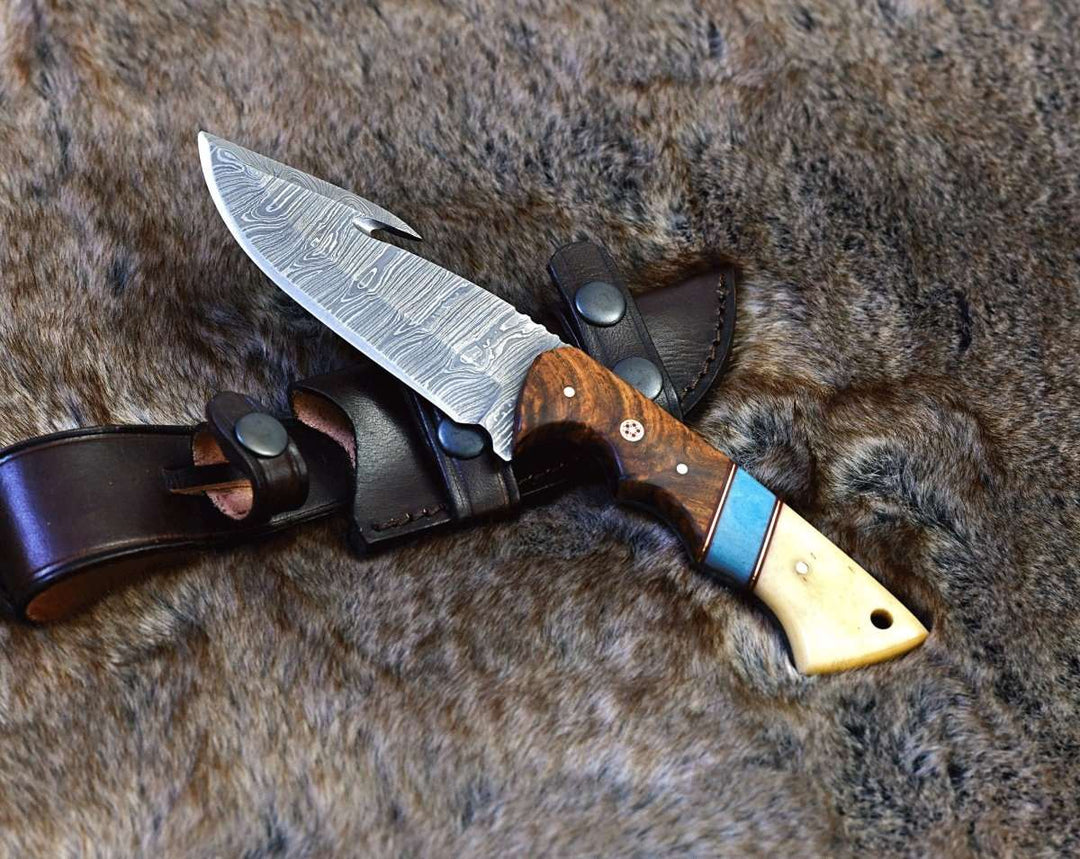 https://www.shokuninusa.com/cdn/shop/products/gravity-damascus-gut-hook-hunting-knife-with-exotic-rose-wood-and-bone-handle-951490.jpg?v=1702091576&width=1080